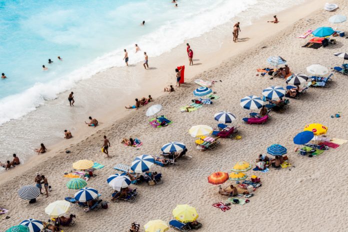 aerial view of parasols and people near beach